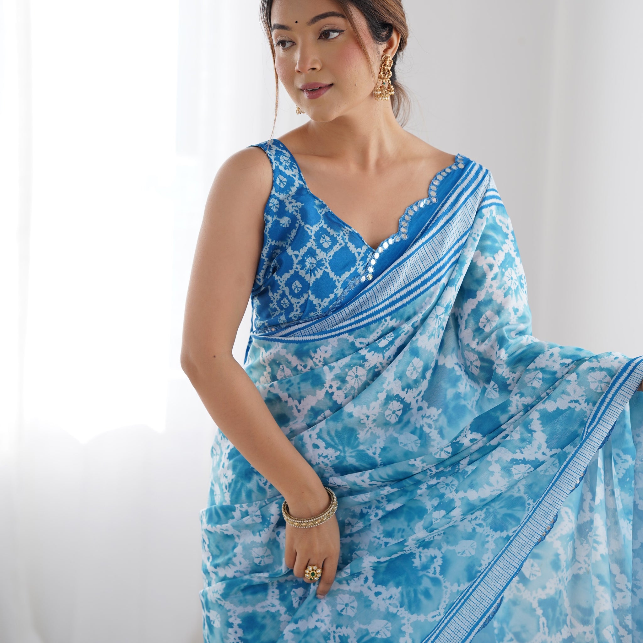 Sky Blue Heavy Chinnon Saree with Print and Kutchi Mirror Lace Border – Available